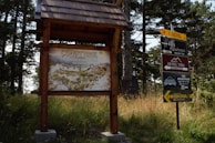 Several parcels of land displayed with signs highlighting their features and prices.