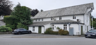A cozy suburban building surrounded by trees and a spacious parking lot.