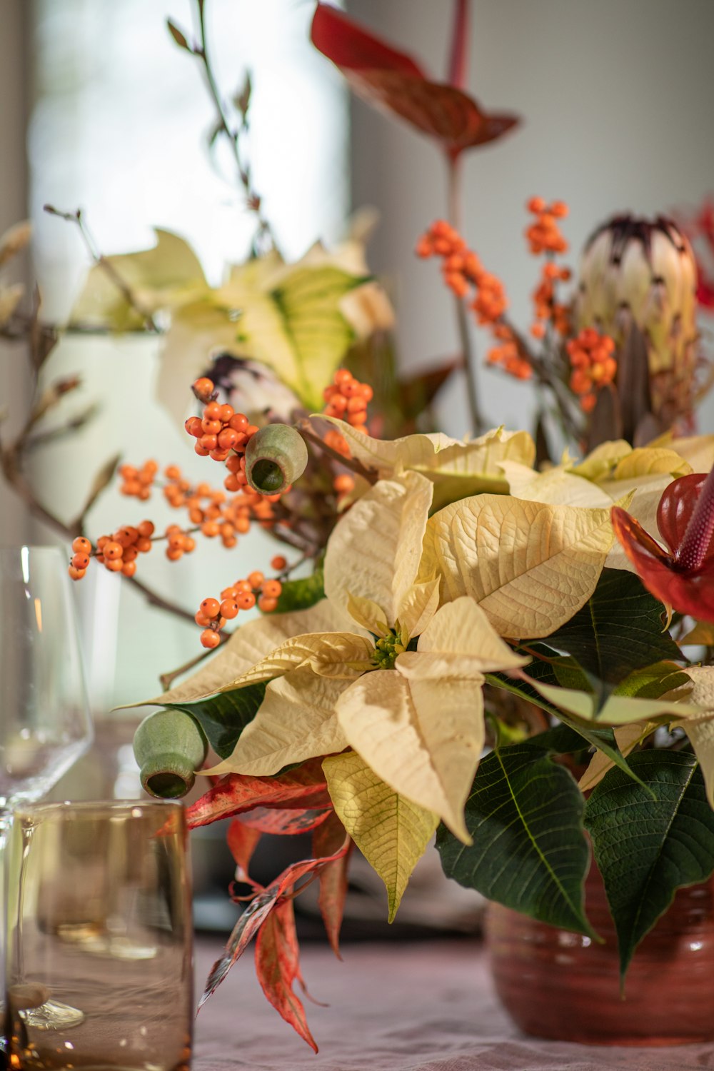 a close up of a vase of flowers on a table