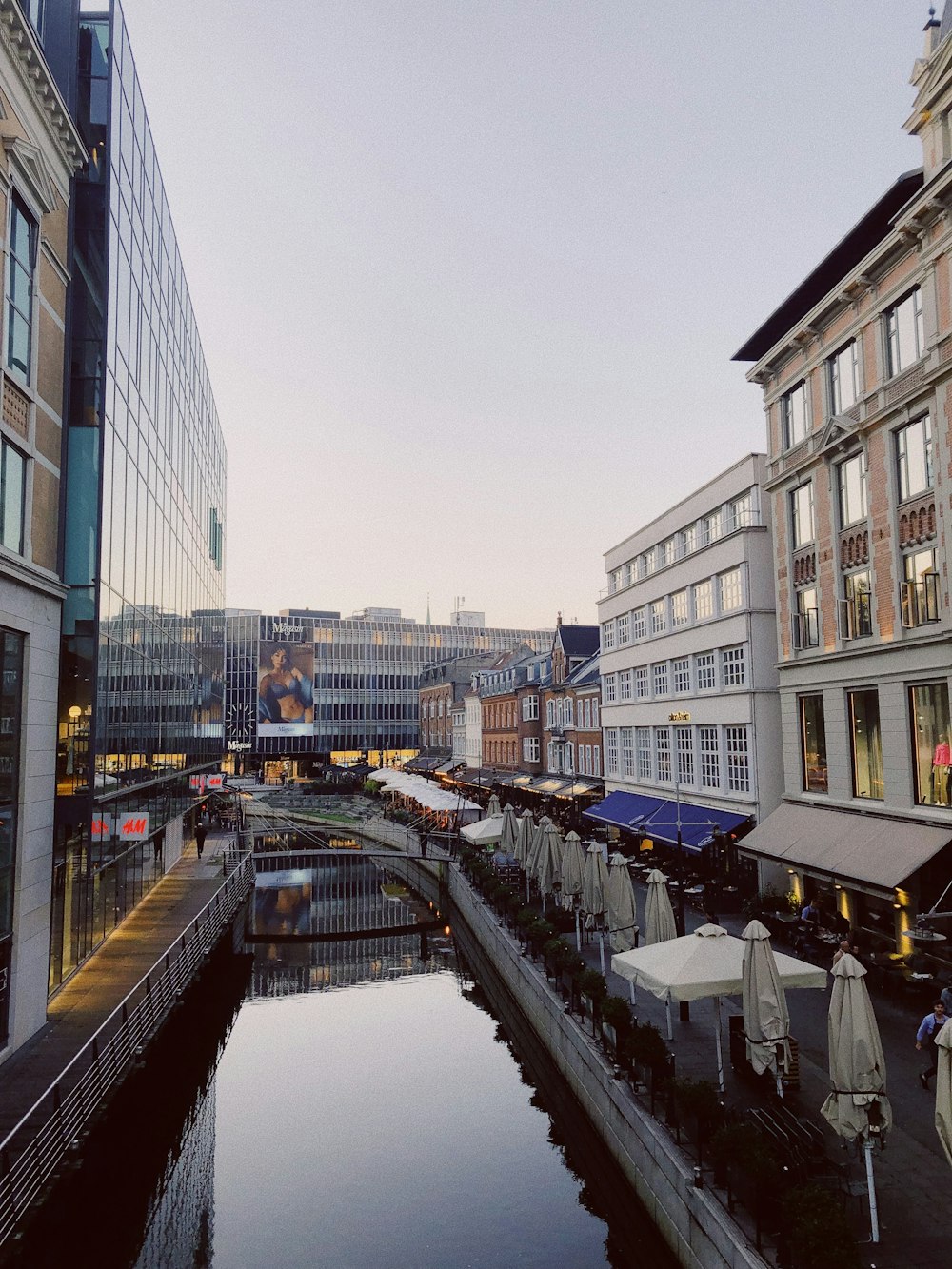 a river running through a city next to tall buildings