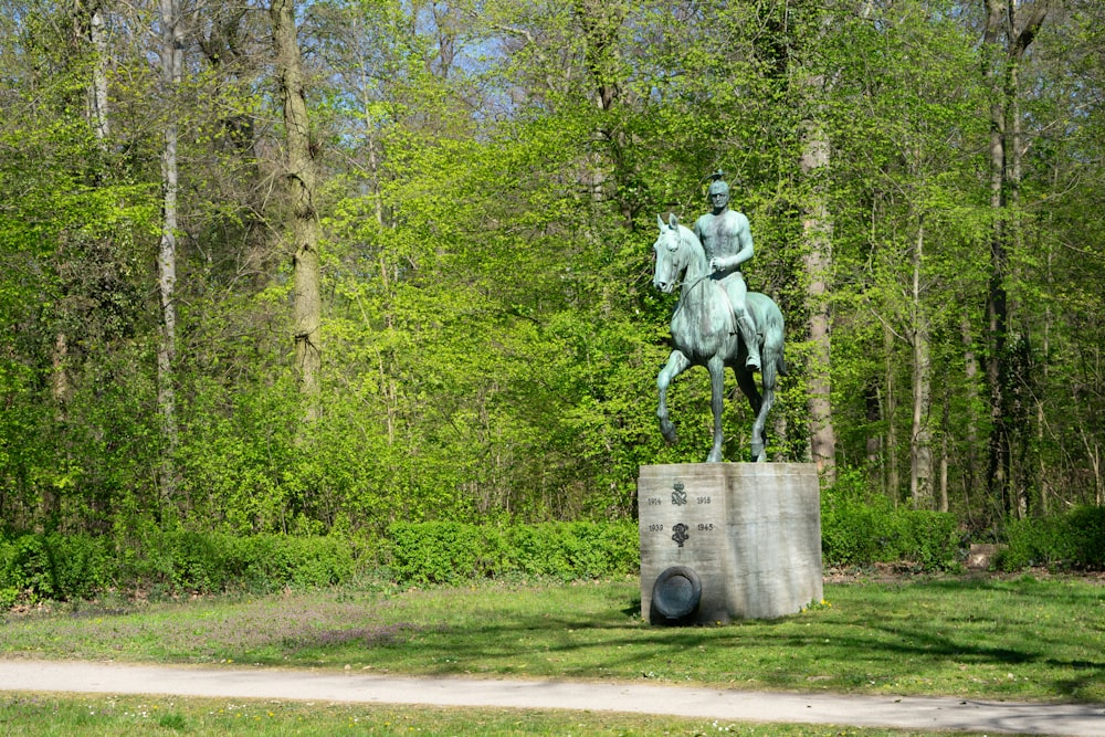 a statue of a man riding a horse in a park