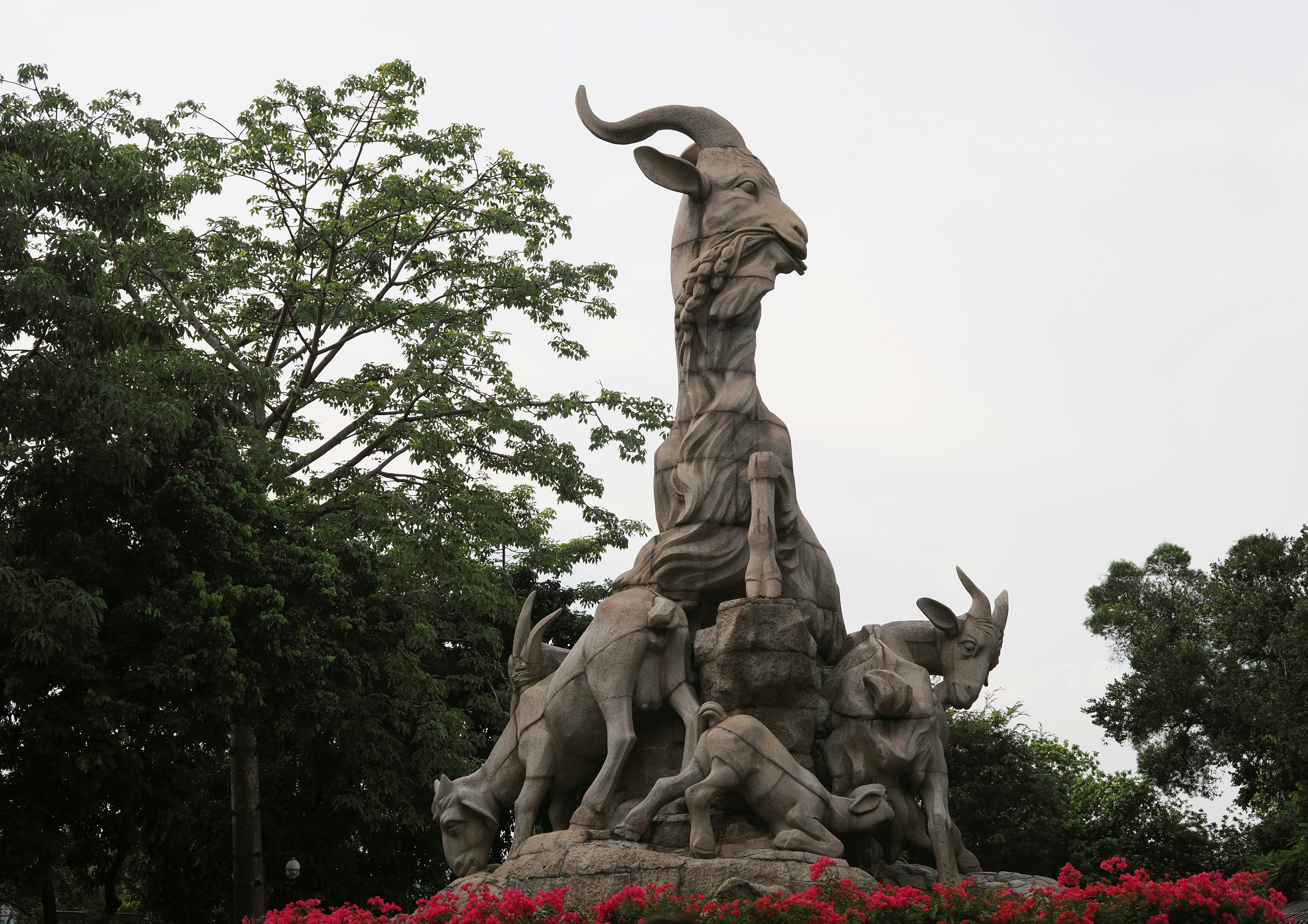 a statue of a woman surrounded by animals