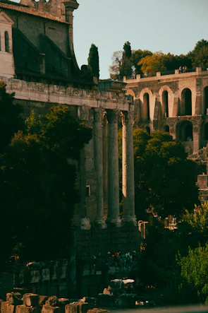 Ancient temple architecture bathed in warm sunlight, surrounded by lush greenery.