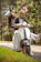 Happy couple riding a double-seater scooter along a sunny coastal road in Tonga.