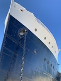 Close-up of precise steel welding on a ship's hull with deep blue tones