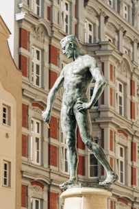 a statue of a man standing in front of a building