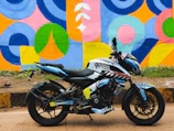A motoveloce motorcycle parked beside a vibrant urban mural, ready for the next ride.