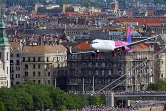 An airplane flying over iconic European landmarks symbolizing new beginnings.