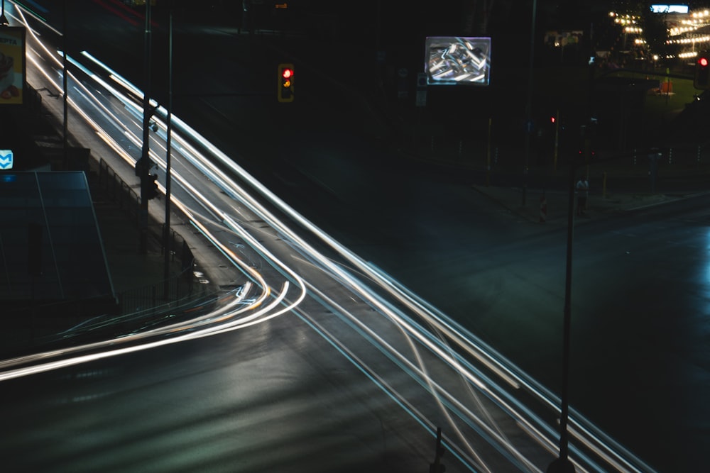 a city street at night with light streaks on the road