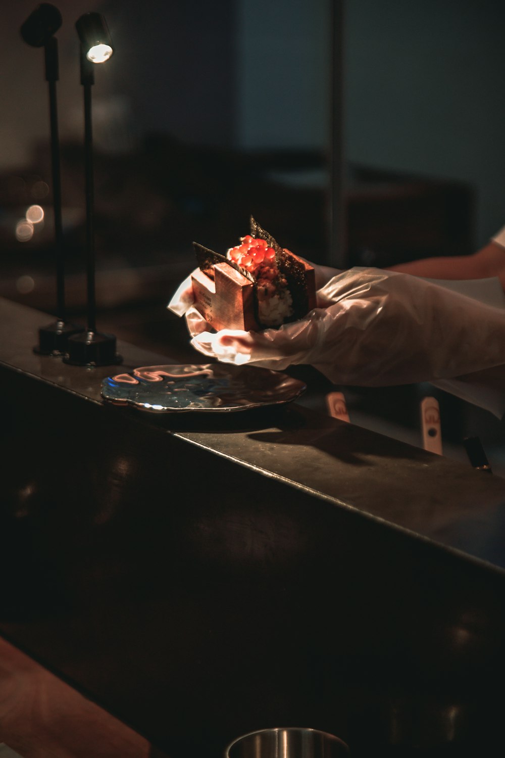 a person holding a piece of cake on a plate