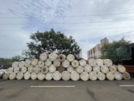 Stacks of industrial chemical drums neatly arranged in a warehouse.