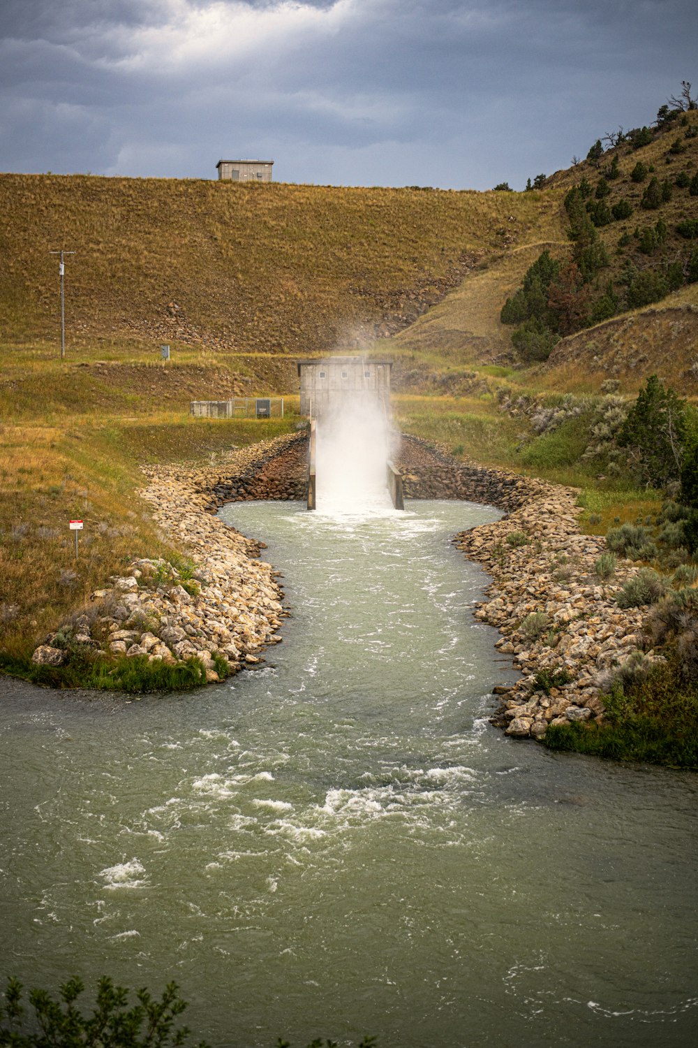 a small waterfall in the middle of a river