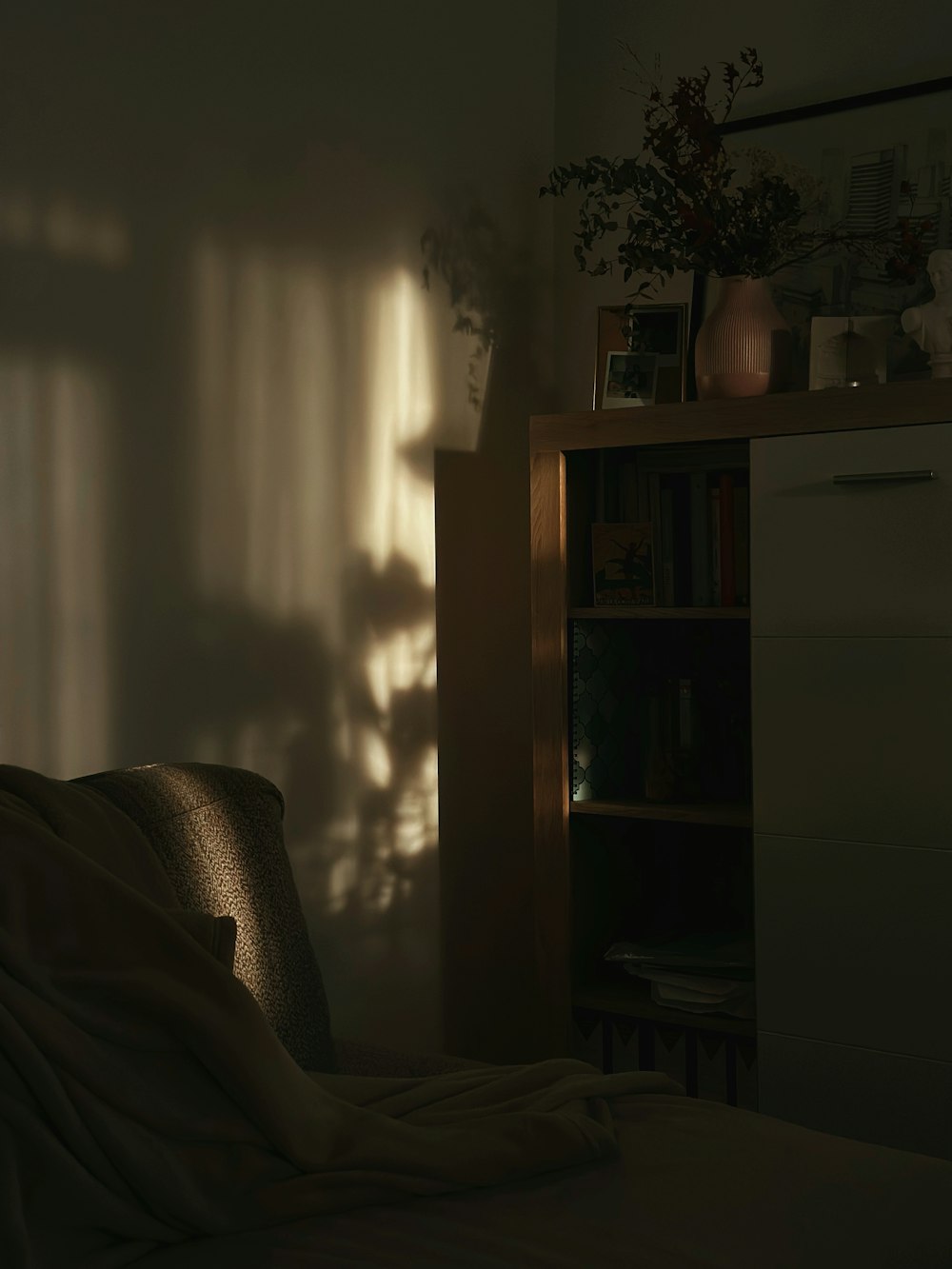 a bedroom with a bed and a book shelf