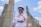 a man standing in front of a tall building