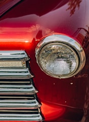 a close up of the front end of a red car