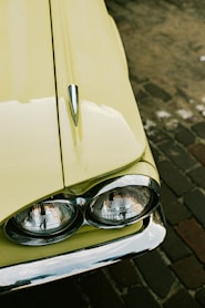 a close up of a car headlight on a brick road