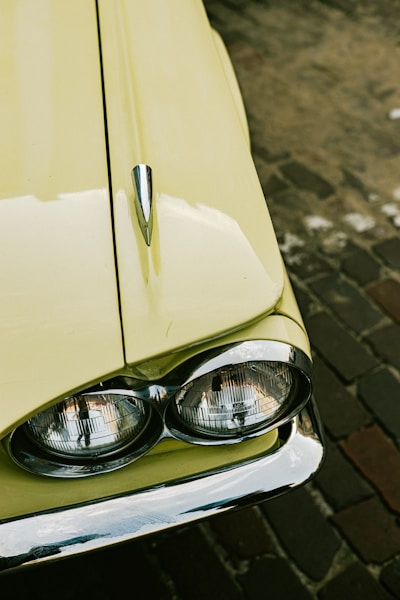 a close up of a car headlight on a brick road