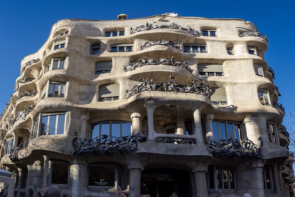 a tall building with lots of windows and balconies