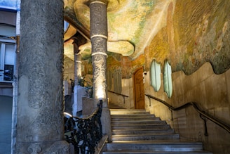a staircase leading up to a painting on the wall