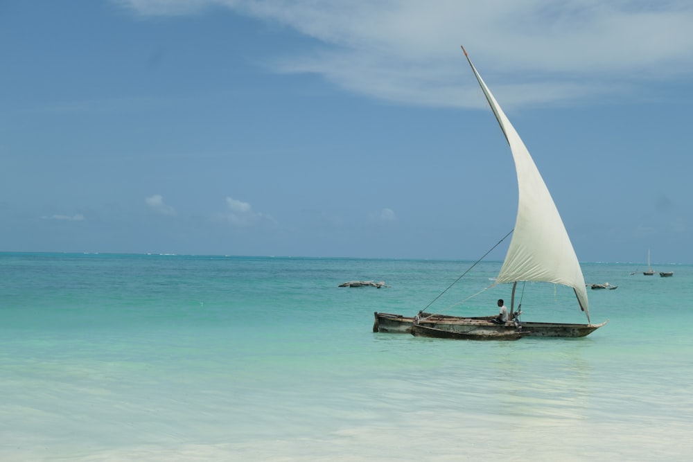 a sailboat floating on top of a body of water