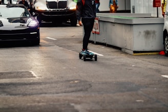A sleek electric skateboard cruising down a city street.
