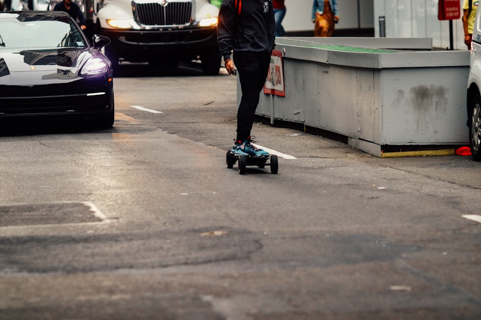 A sleek electric skateboard cruising down a city street.