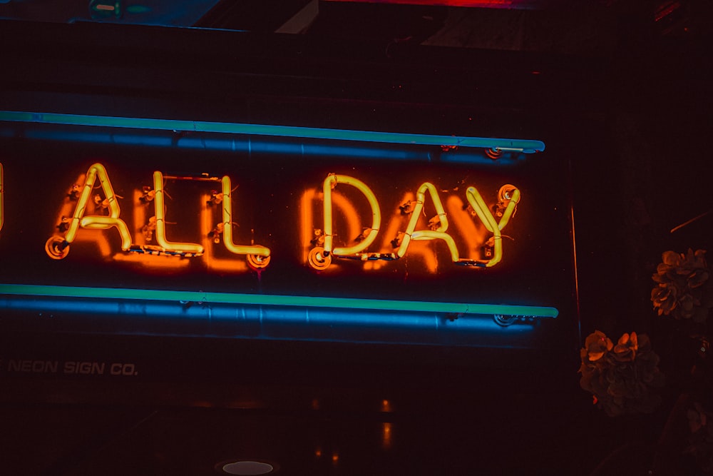 a neon sign that says all day on it