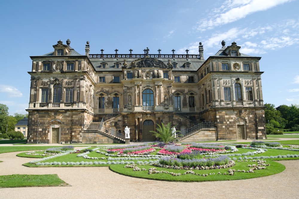 a large building with a garden in front of it