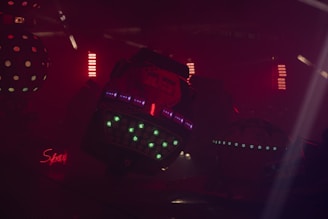 A dark setting featuring several small 3D parts laid out, each with a warm glow emphasizing their precision.