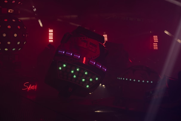 A dark setting featuring several small 3D parts laid out, each with a warm glow emphasizing their precision.