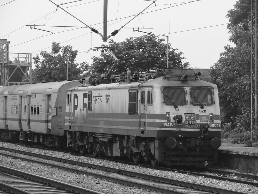 a black and white photo of a train on the tracks