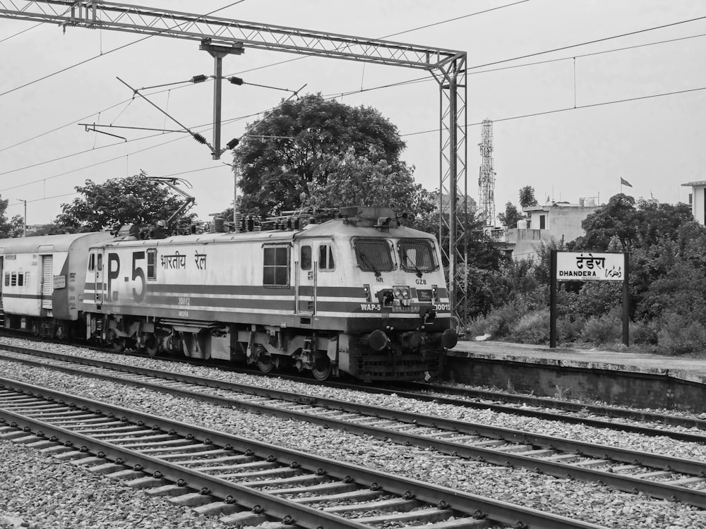 a black and white photo of a train on the tracks