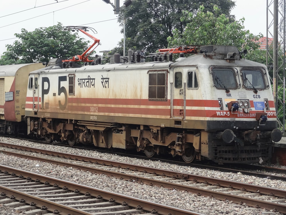 a train on a train track with trees in the background