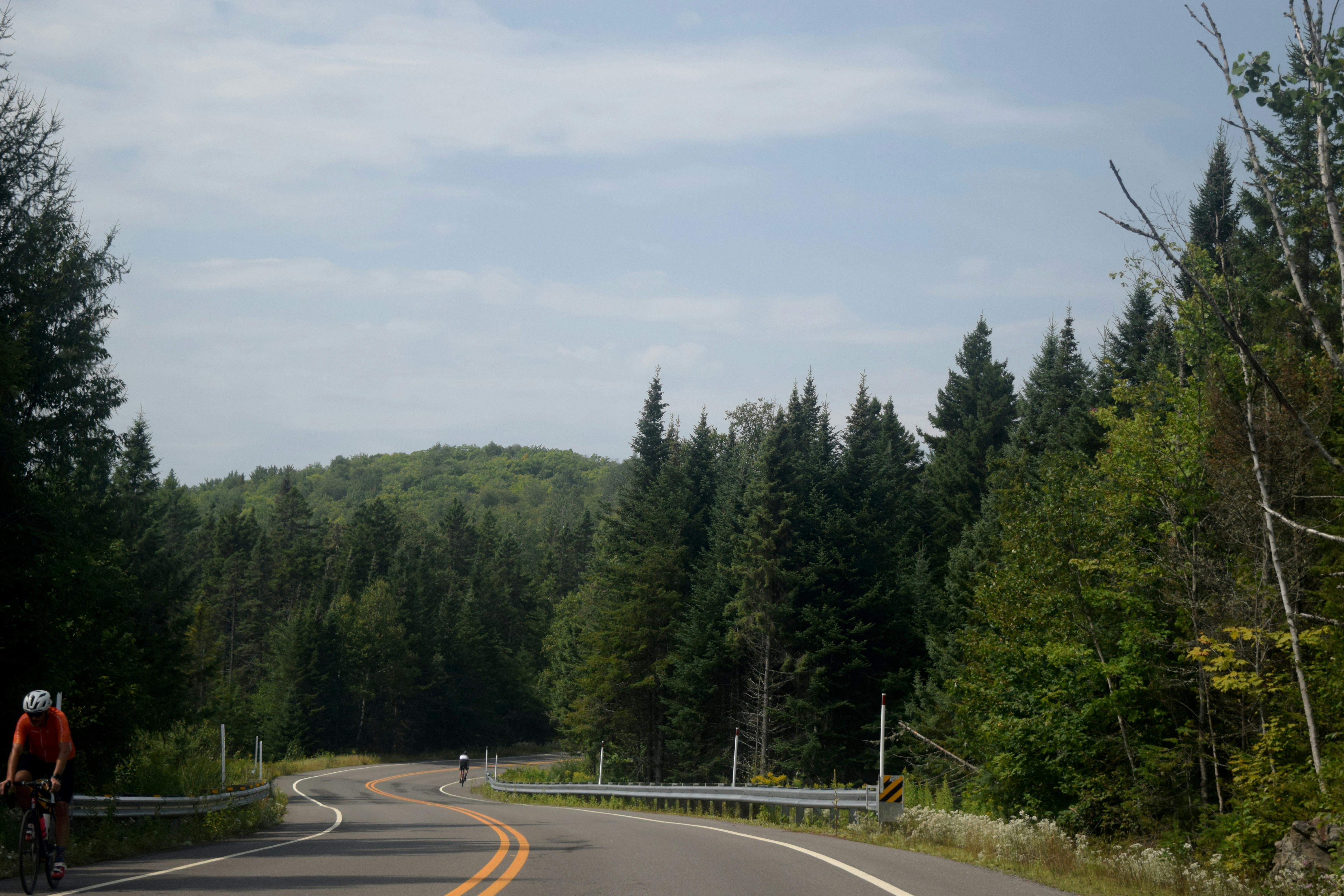 a man riding a bike down a curvy road