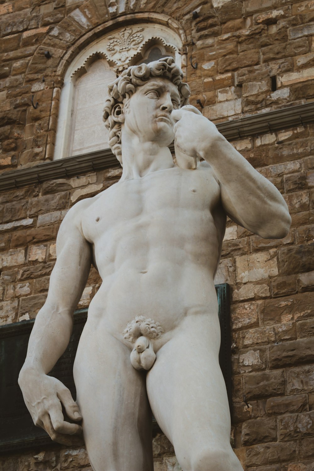 a statue of a man standing in front of a building