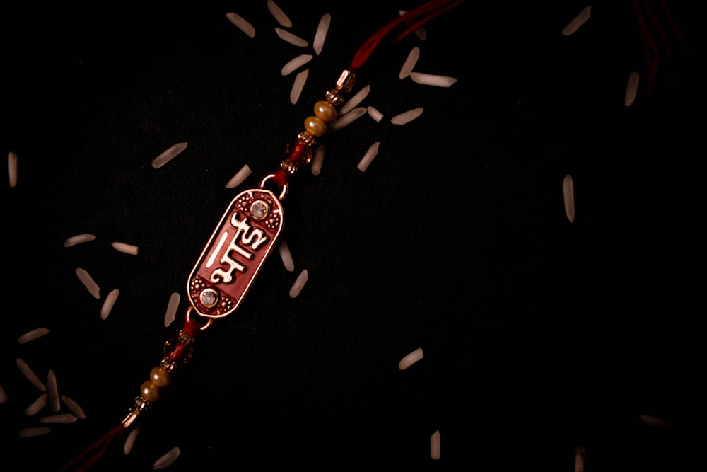 a red and white long beaded necklace with a red and white sign on it