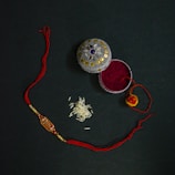 A neatly arranged pooja kit featuring essential items like kumkum, rice, and bells.