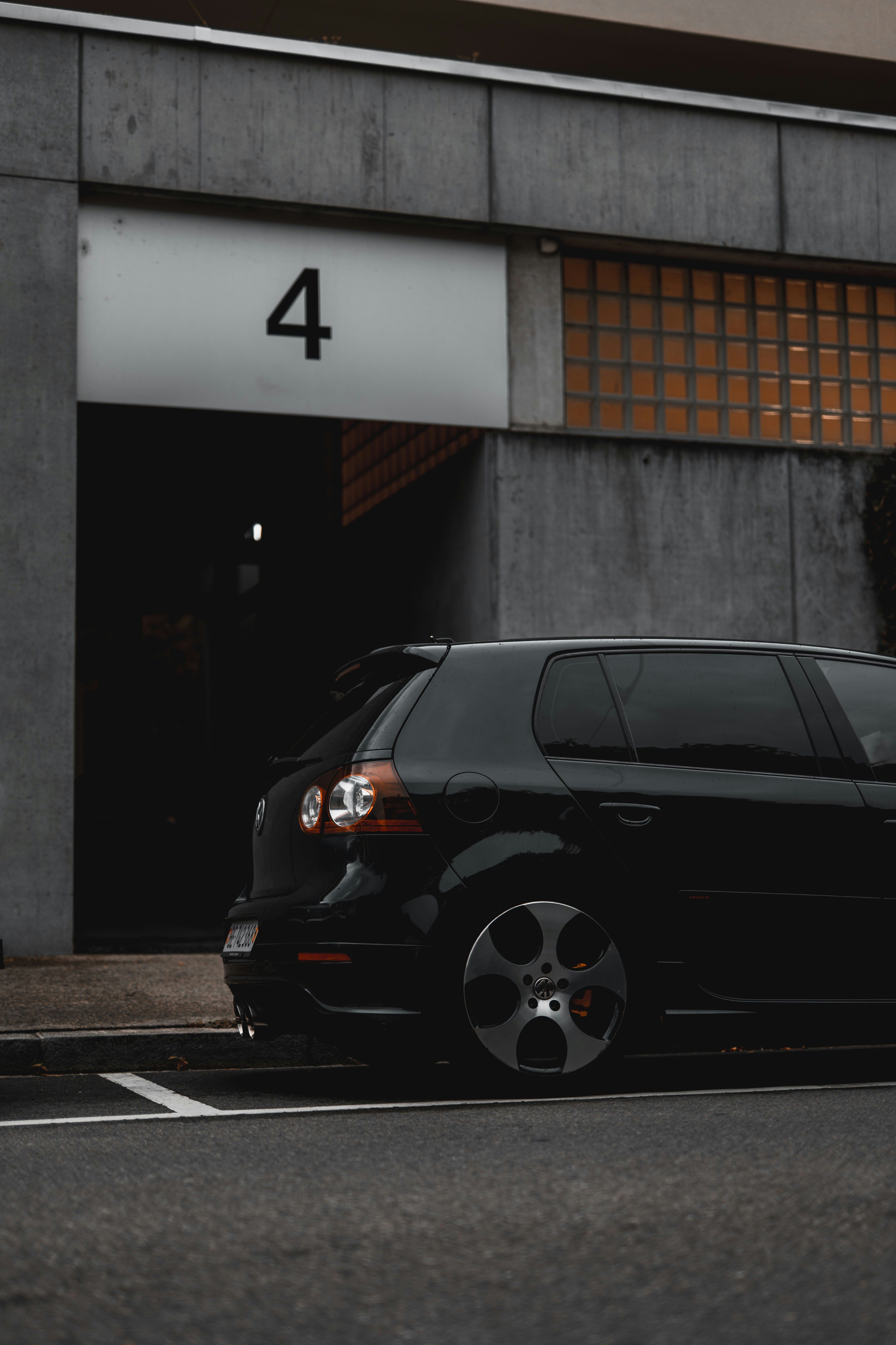 A black car parked in front of a building photo – Free Machine Image on ...