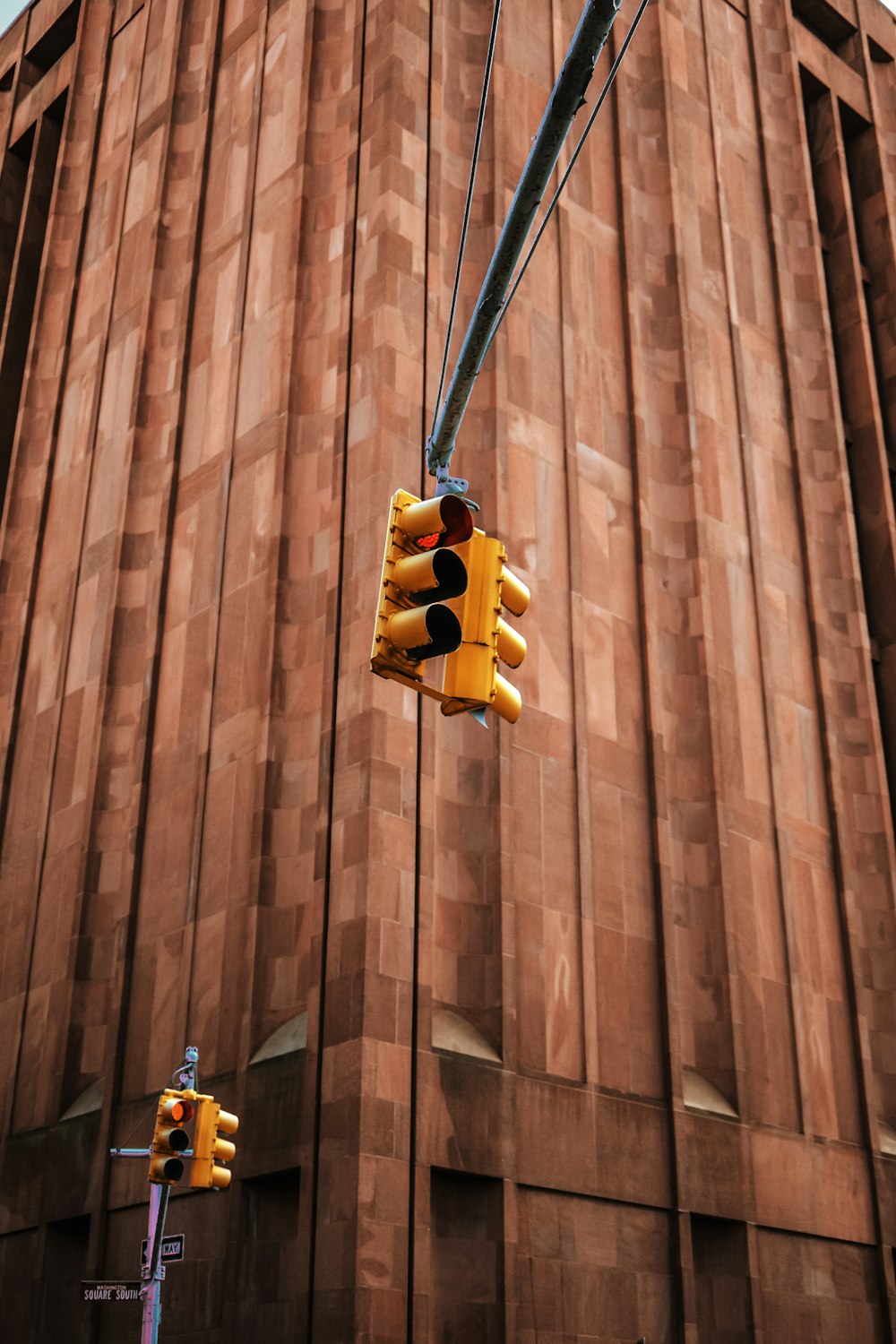 a traffic light hanging from the side of a tall building