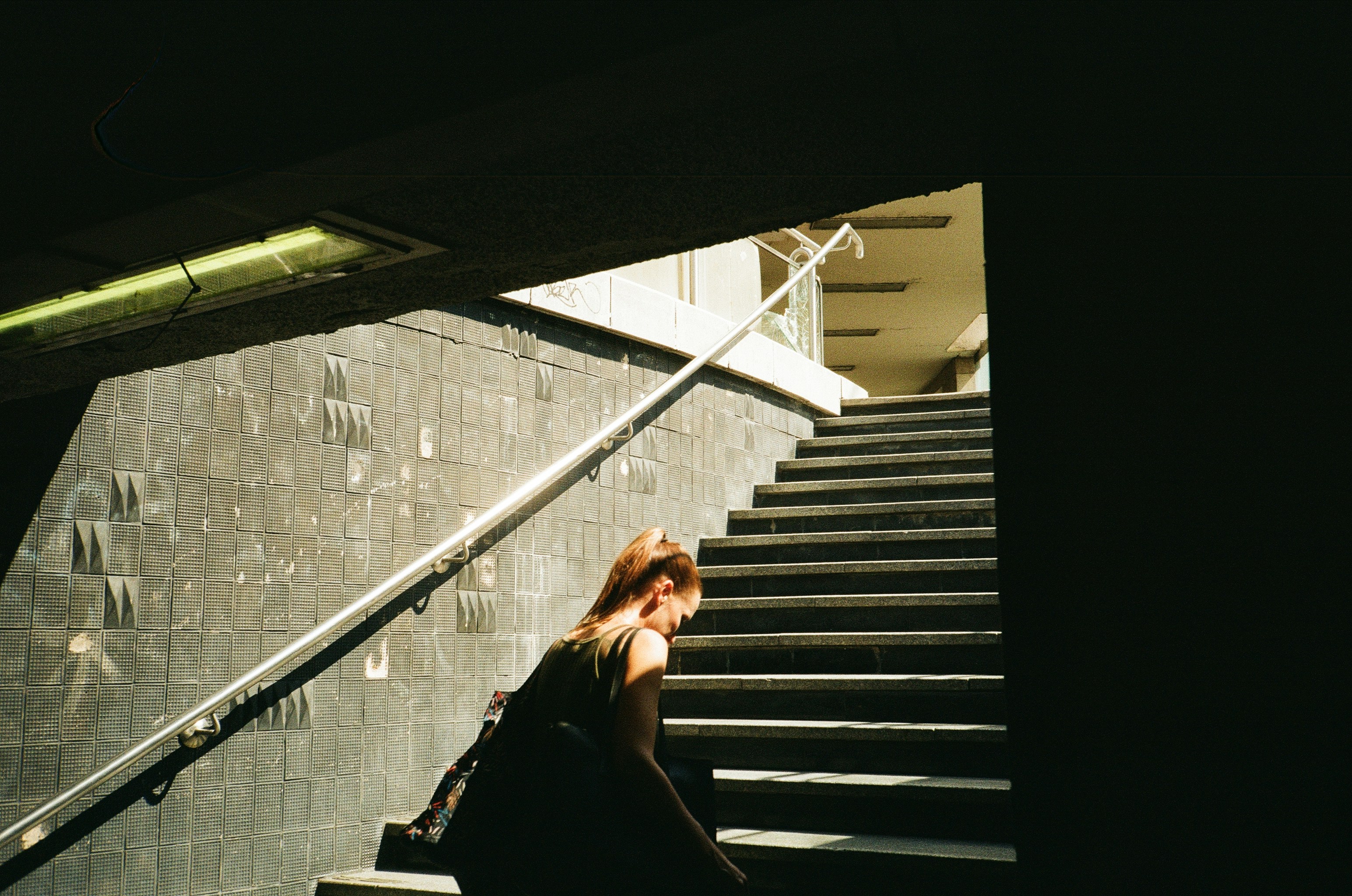 a woman sitting on a set of stairs