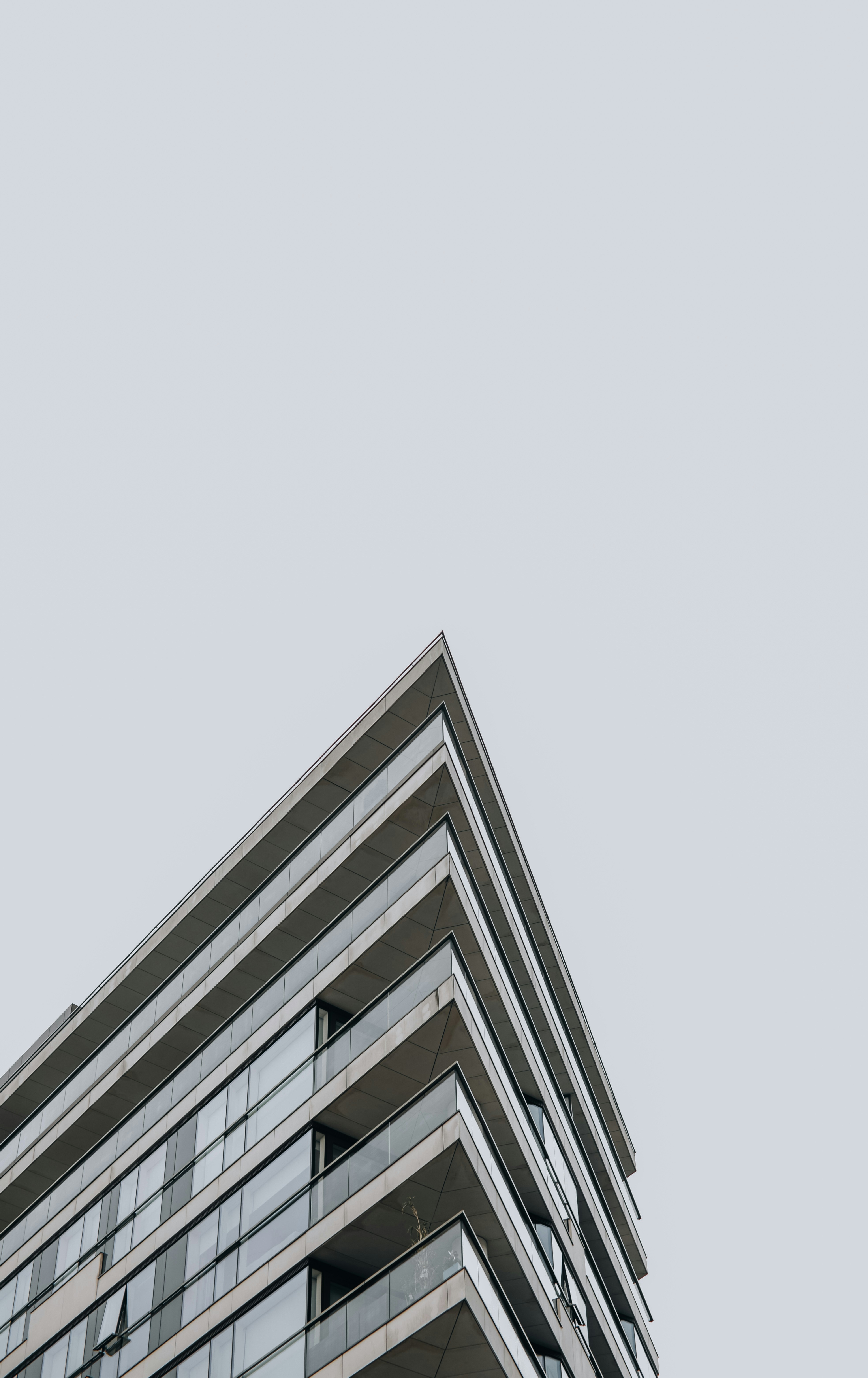 an airplane flying in the sky over a building