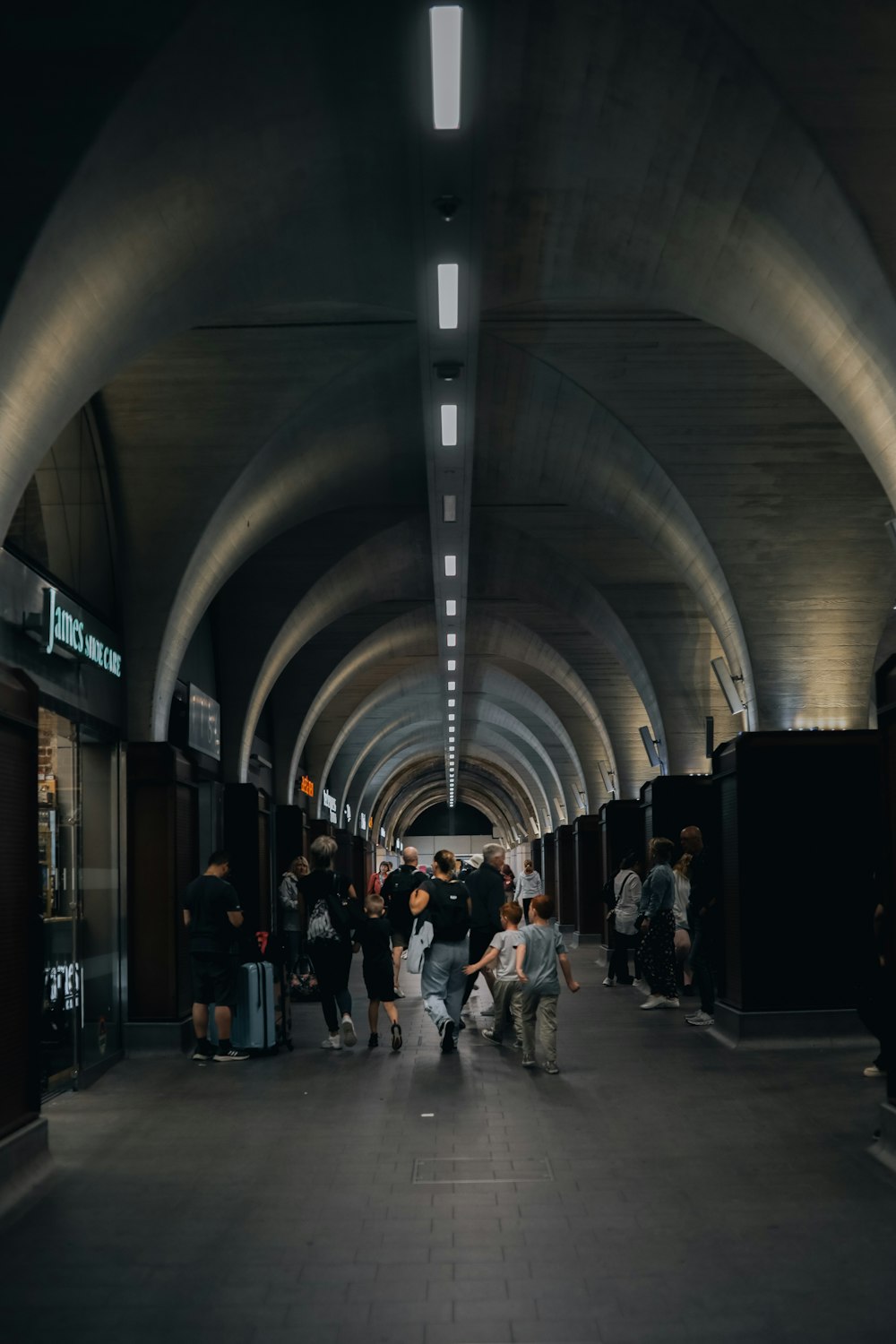 a group of people walking through a tunnel