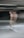 A blurred motion capture of a person on a skateboard, creating a ghostly effect. The person appears to be moving, with their image duplicated and smeared across the scene. The background is dark and indistinct, emphasizing the movement of the figure.