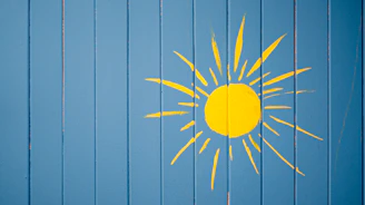 Vibrant comic-style illustration of a sun wearing sunglasses over a cyan background with bold yellow and red accents.