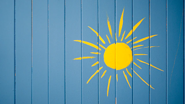 Vibrant comic-style illustration of a sun wearing sunglasses over a cyan background with bold yellow and red accents.