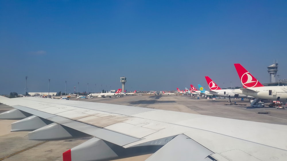 a bunch of airplanes that are on a runway