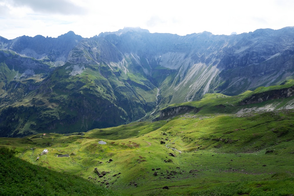 a view of a valley with mountains in the background