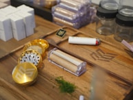 Various smoking paraphernalia including rolling papers, grinders, and pipes arranged neatly.