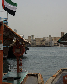 Traditional dhow boats sailing along Dubai’s sparkling coastline.