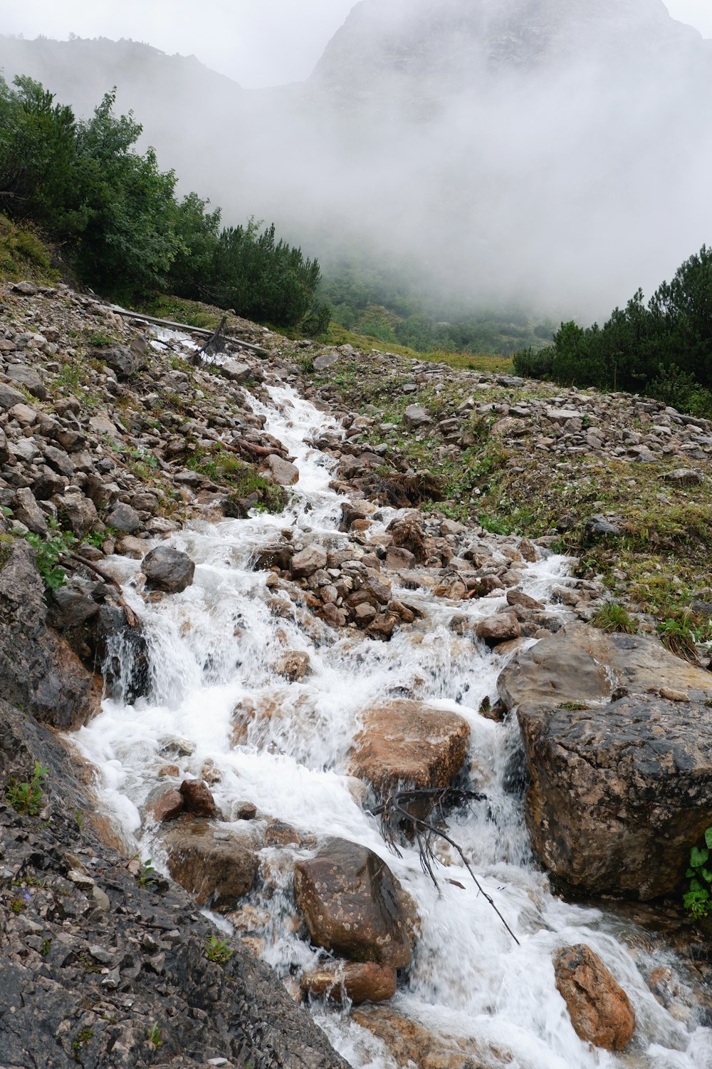 a stream of water running between some rocks